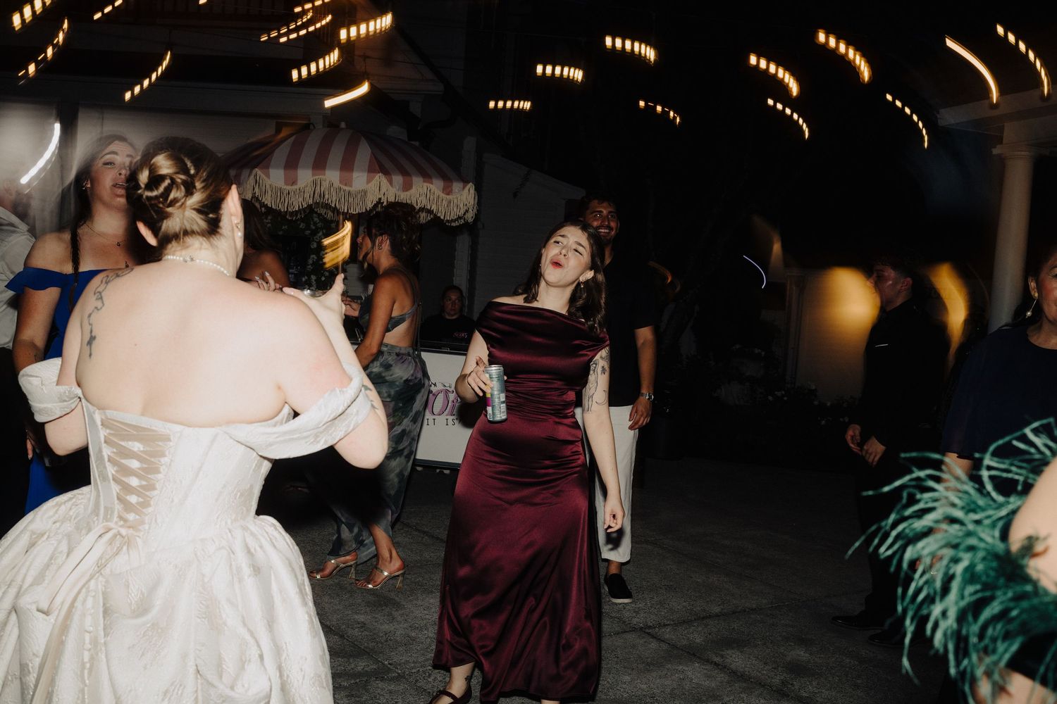 Wedding reception dance floor with warm string lights creating romantic ambiance.