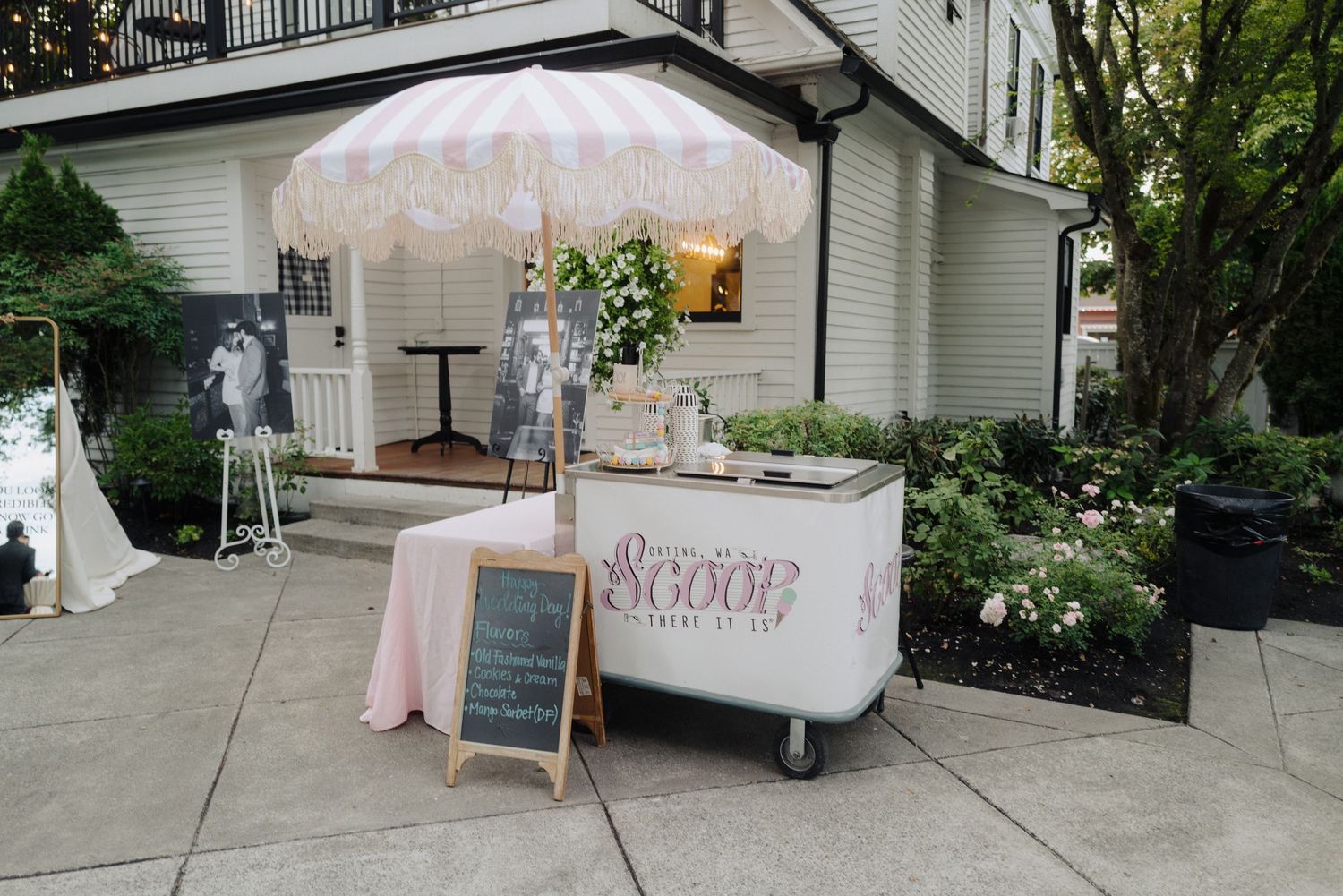 Wedding reception area with cotton candy cart and outdoor decorations.
