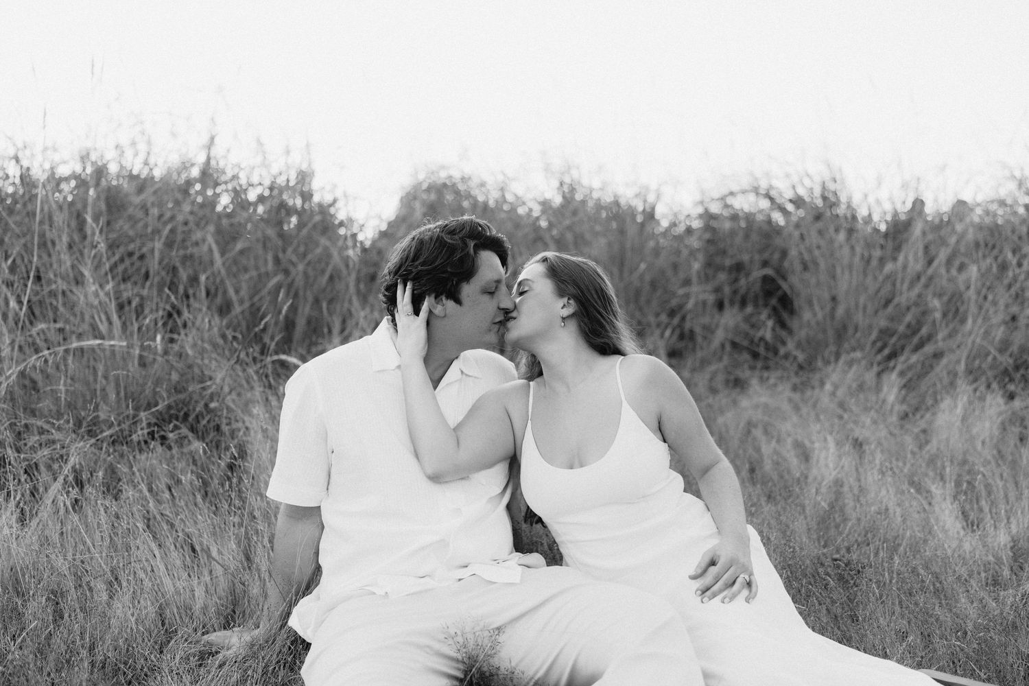 Intimate couple's portrait session in tall grass field.