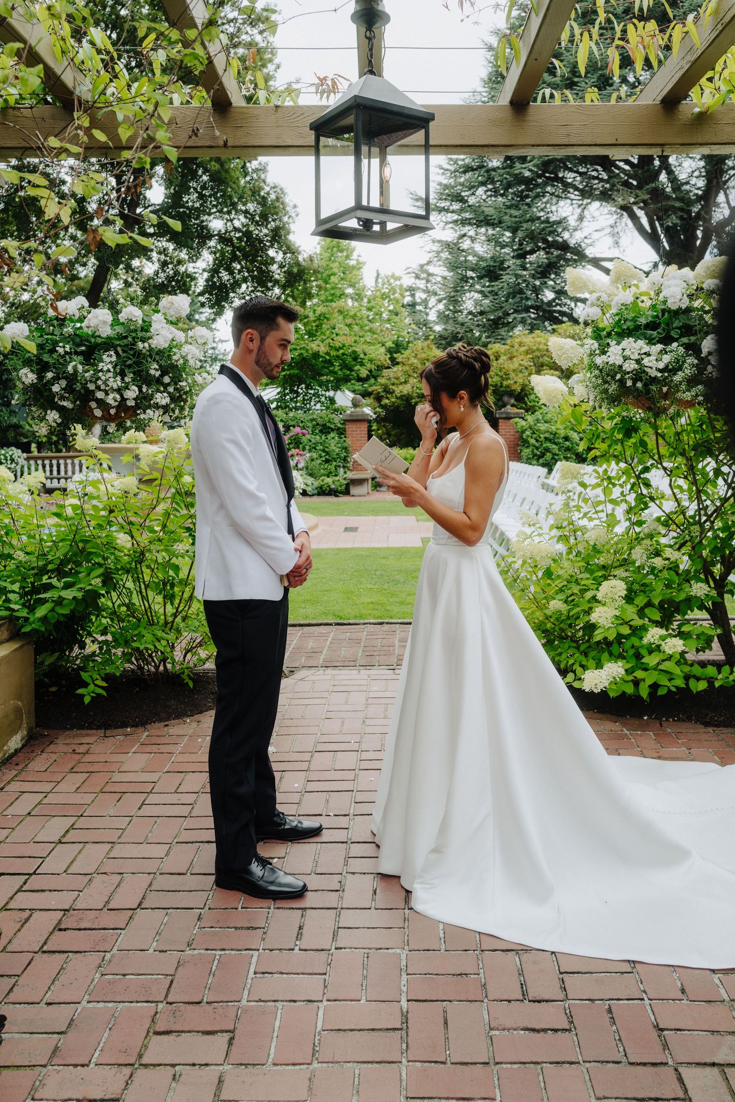 A first look moment between a couple on their wedding day captured in a series of candid photos on a brick patio.