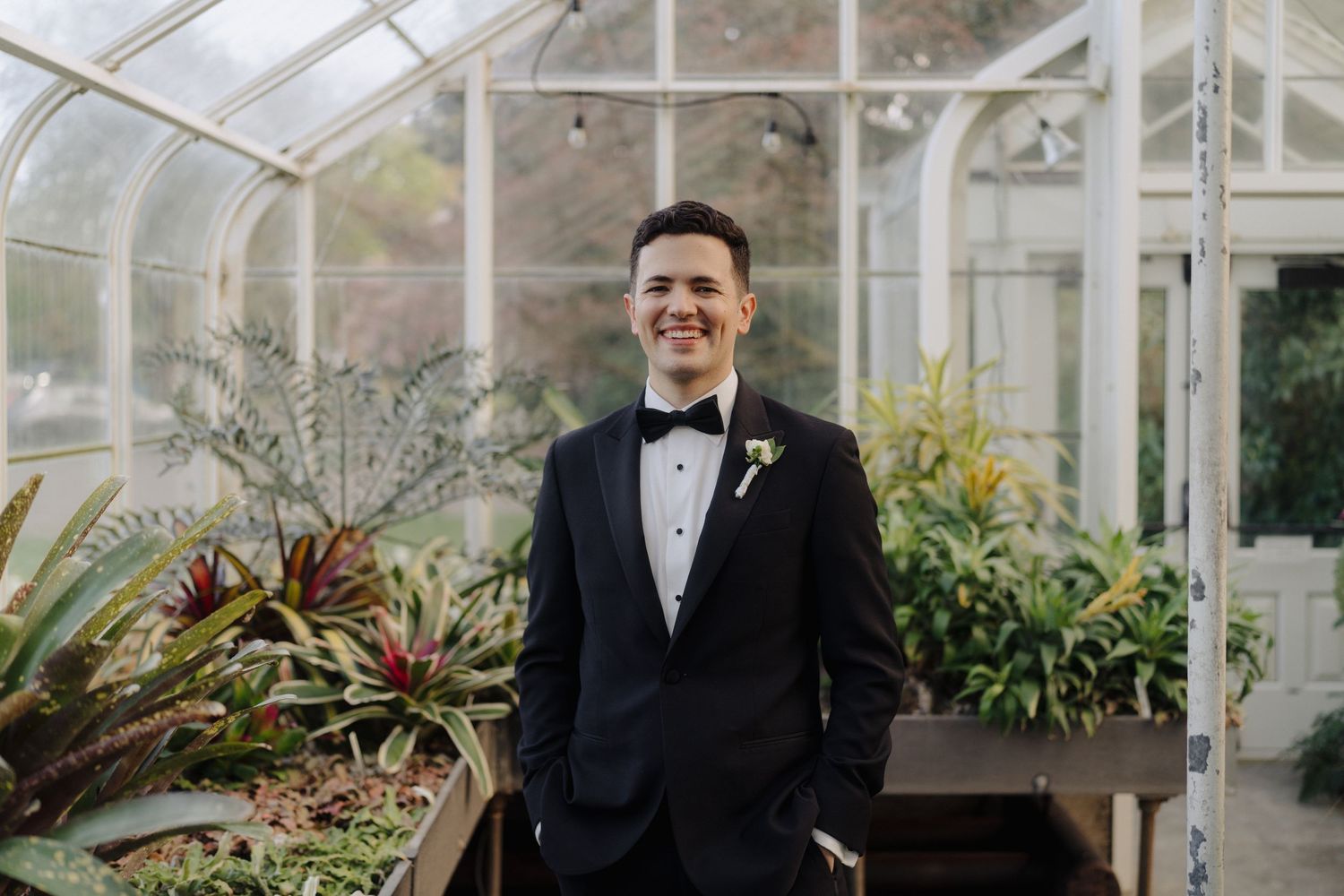 Classic formal wedding portraits taken in an elegant greenhouse setting.