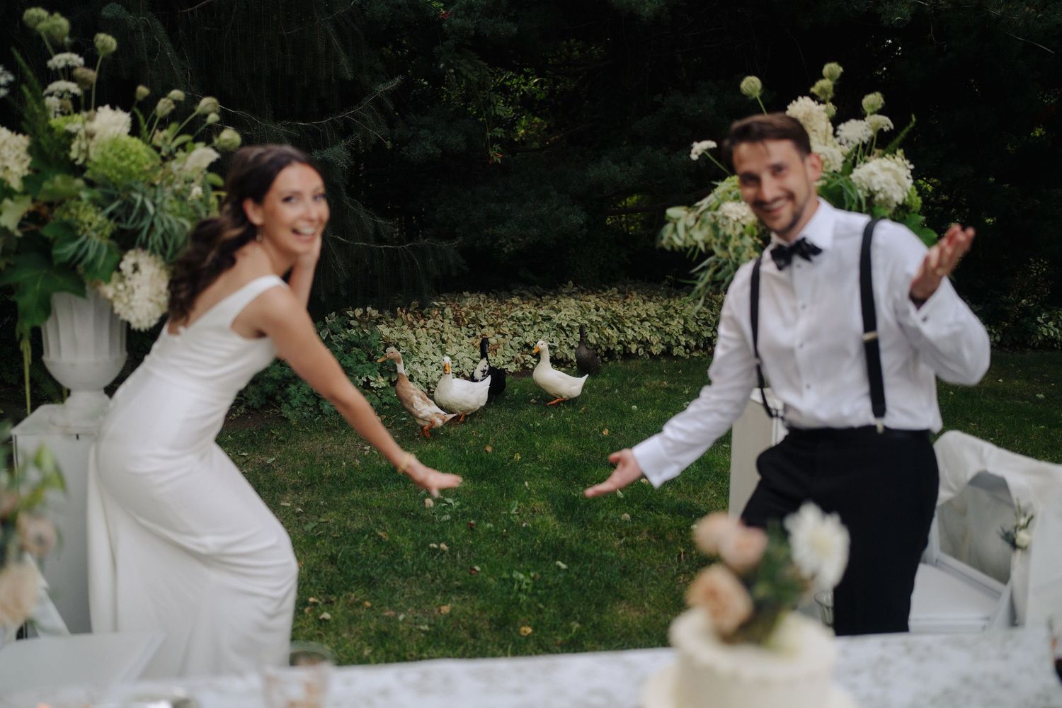 Joyful wedding celebration in an outdoor garden setting with white dress and casual attire.