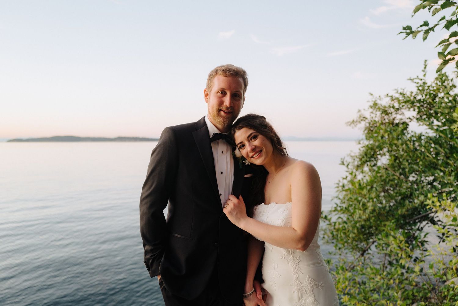 Romantic sunset wedding portraits captured on a scenic waterfront deck.