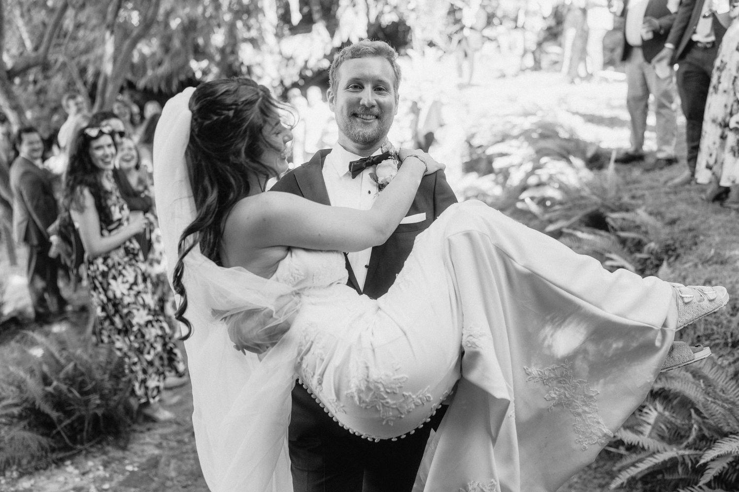 Joyful celebration moment during an outdoor wedding ceremony.