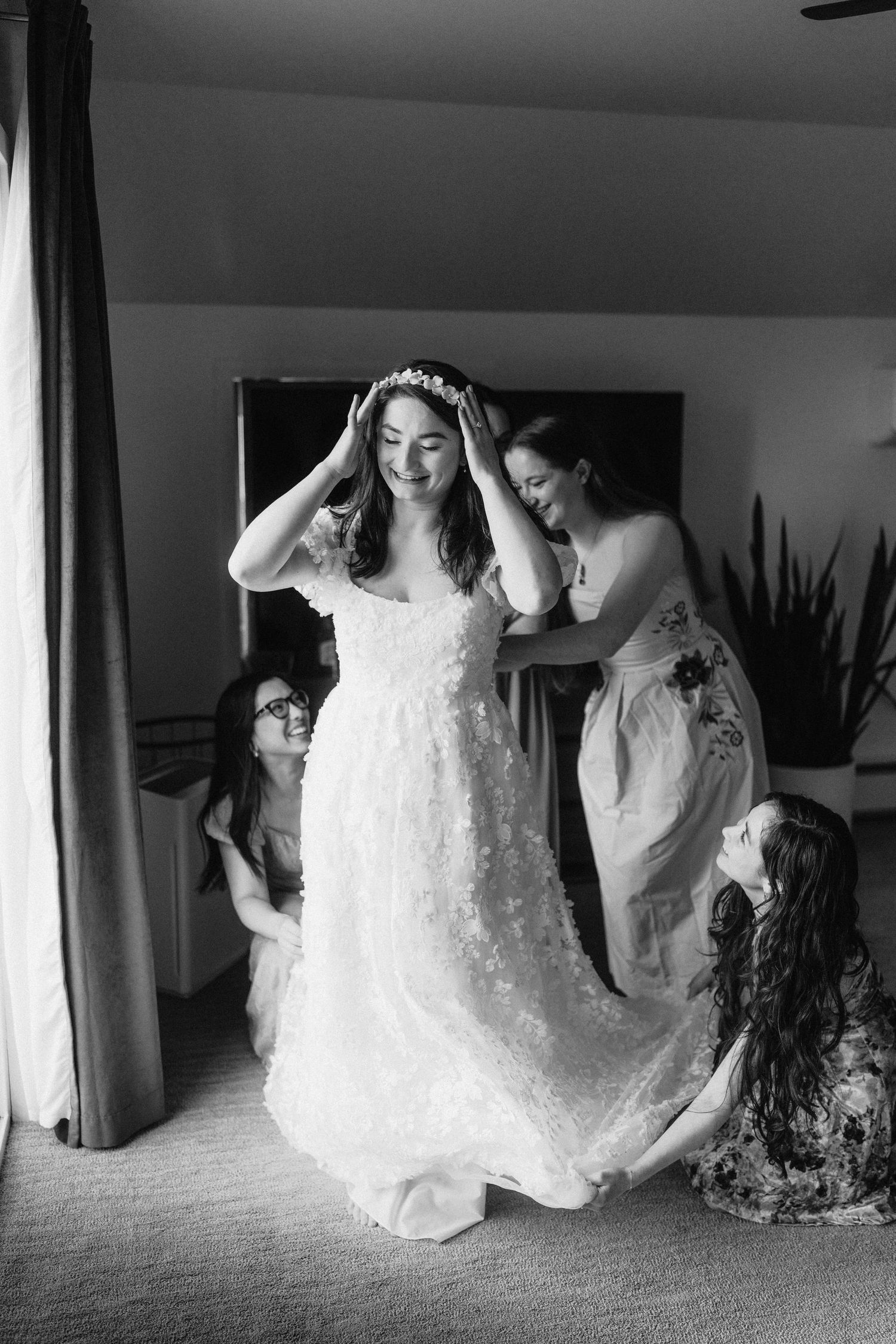 Black and white photo series showing the bride getting ready in her elegant lace wedding dress.