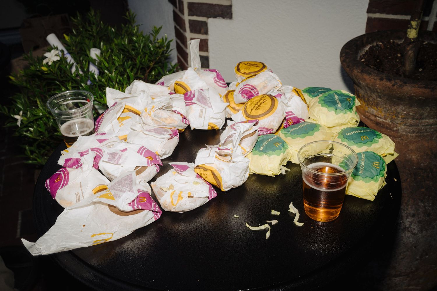 Colorful party decorations and drinks scattered across a dark surface.