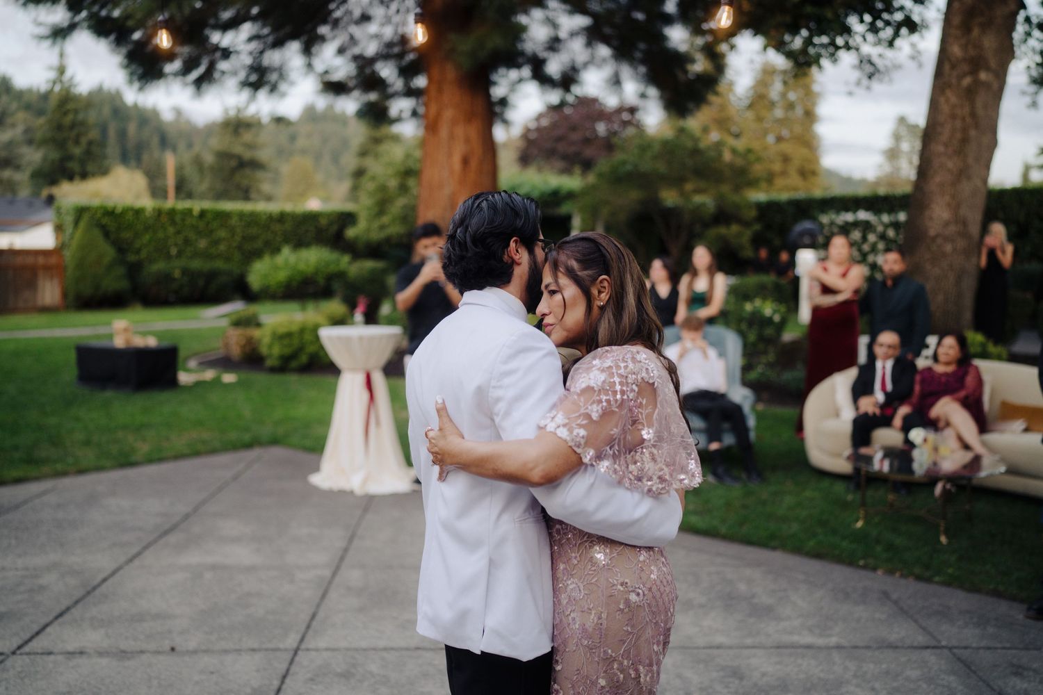 Couple sharing an intimate dance moment on an outdoor patio during their wedding reception.