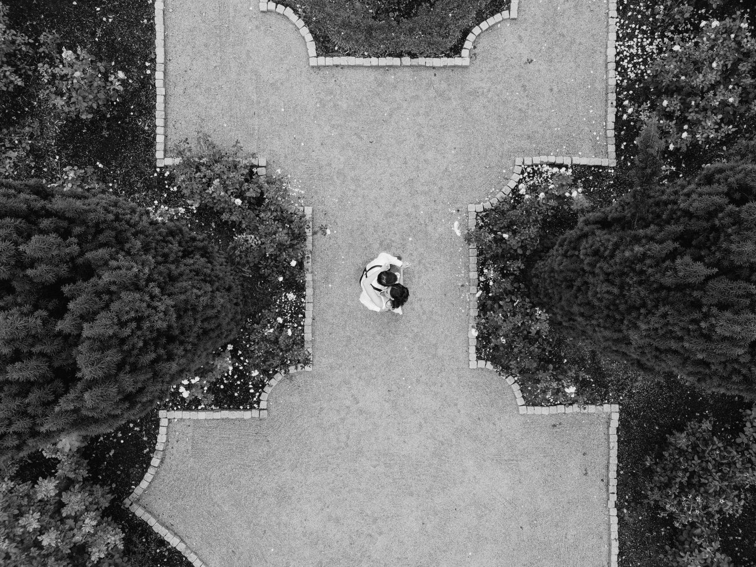 Aerial black and white view of an outdoor wedding venue setup with chairs arranged in rows.