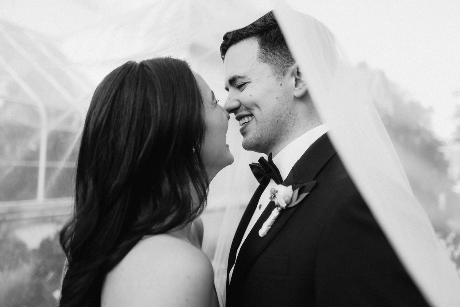 Black and white portrait of a tender moment between newlyweds.