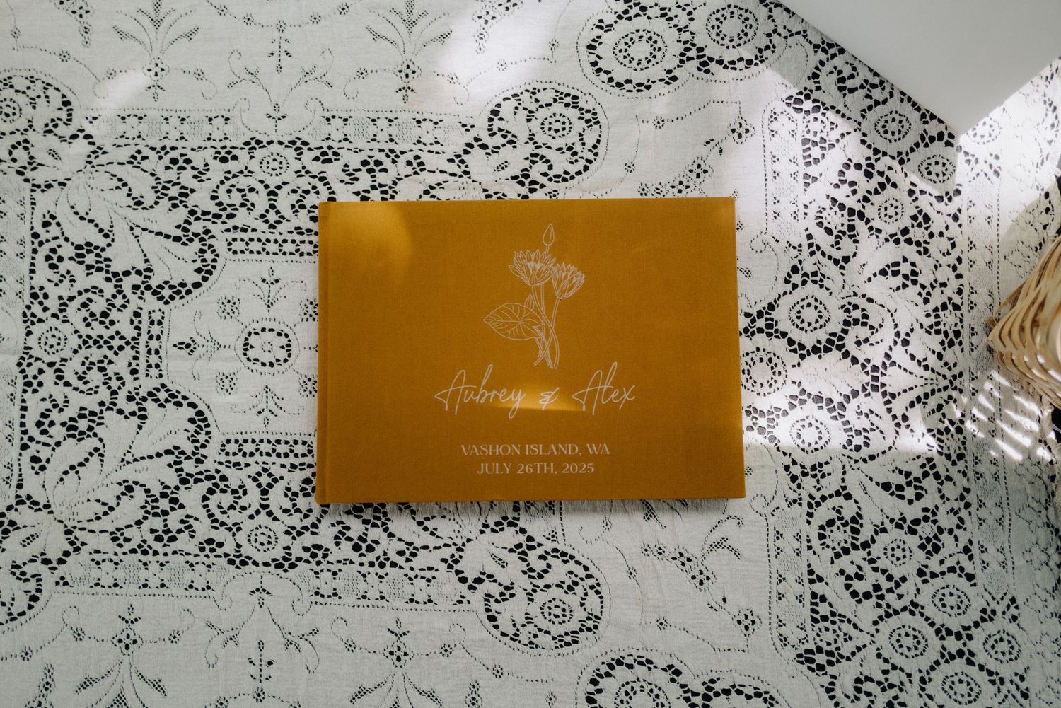 A golden wedding invitation displayed on a decorative patterned background.