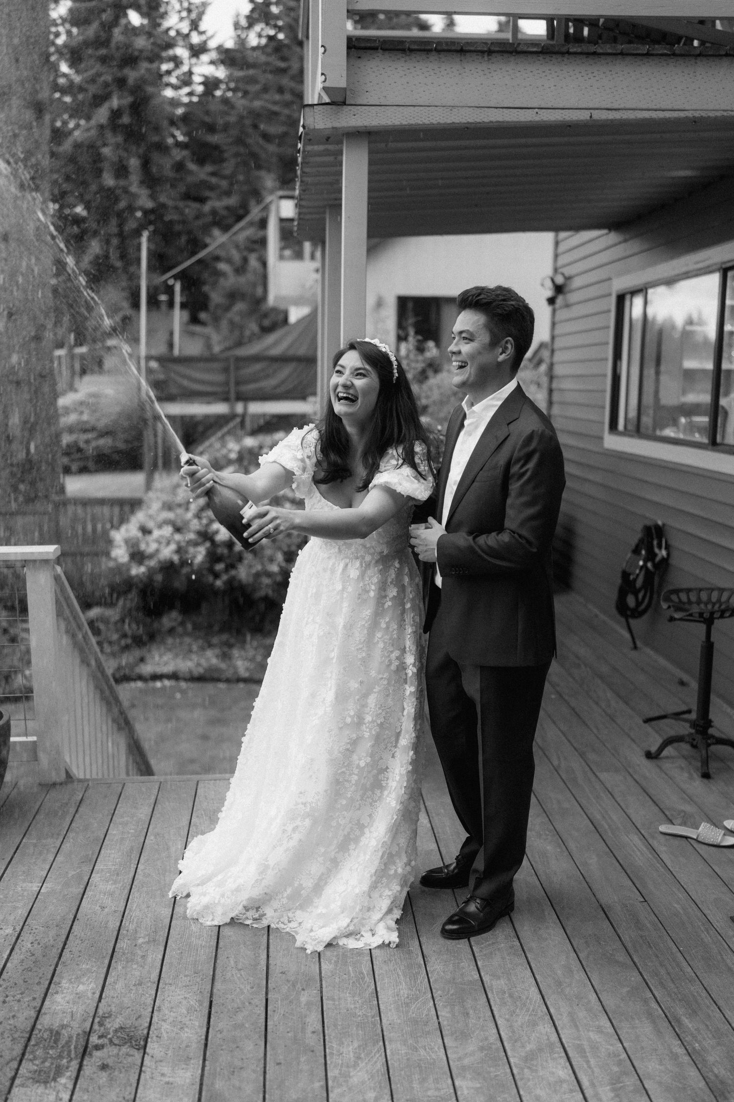 Couple dancing together on a rustic wooden porch with natural lighting.