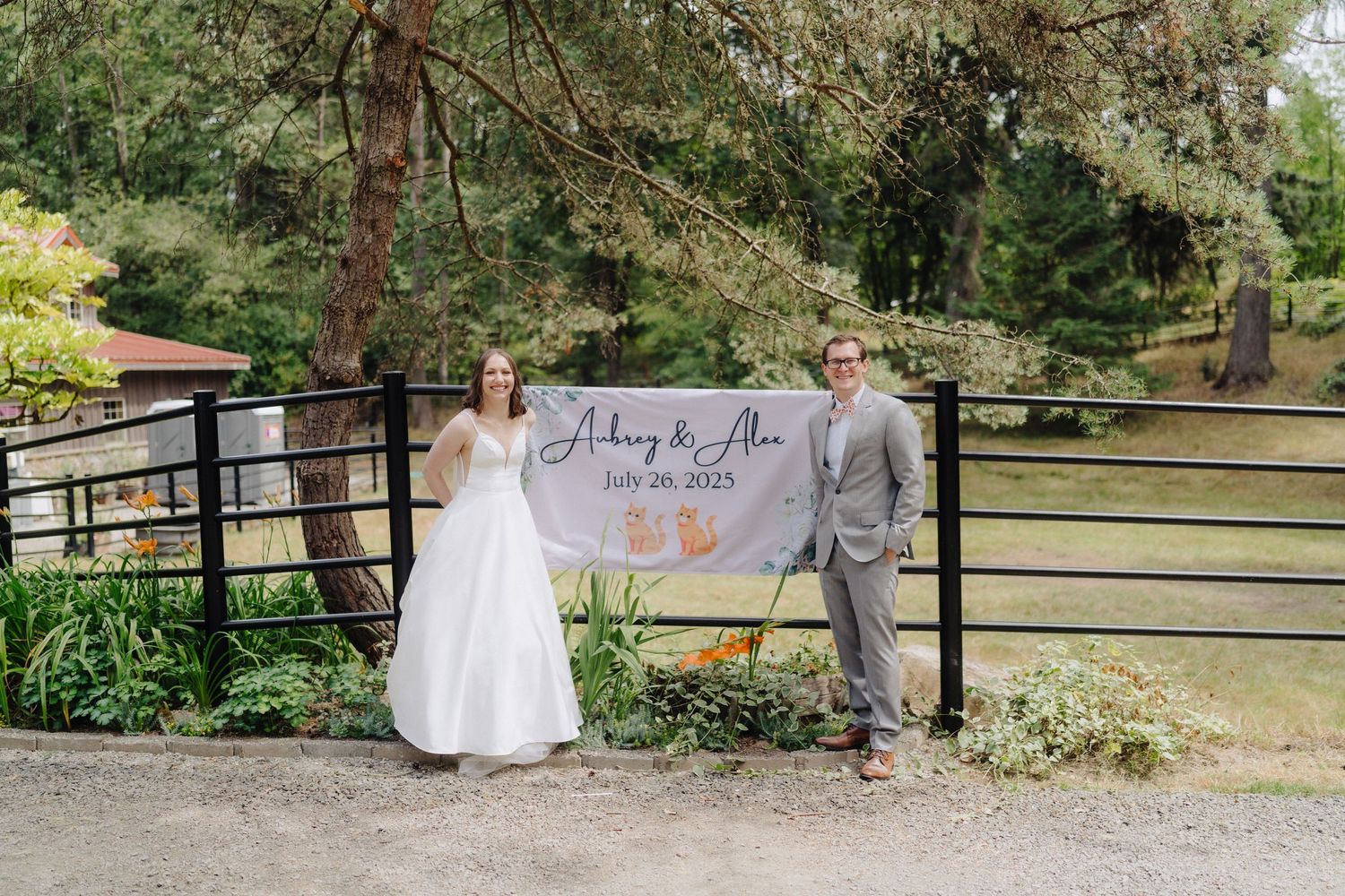 Rustic wedding venue setting with wooden fencing and decorative welcome signage.