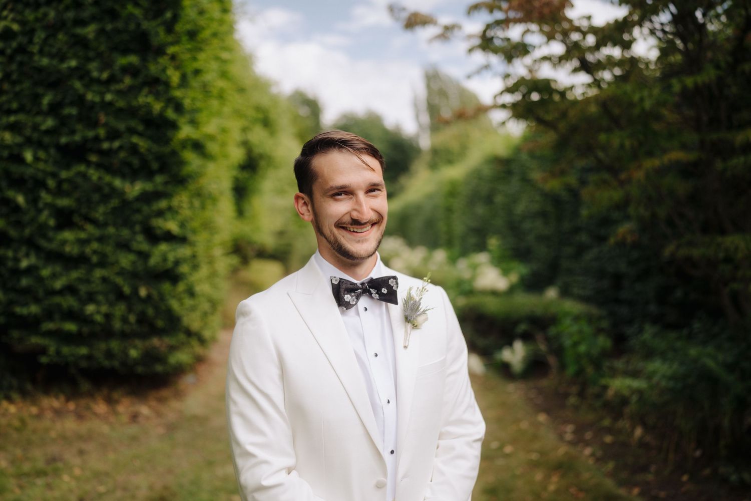 Outdoor wedding portrait session in a scenic garden pathway.