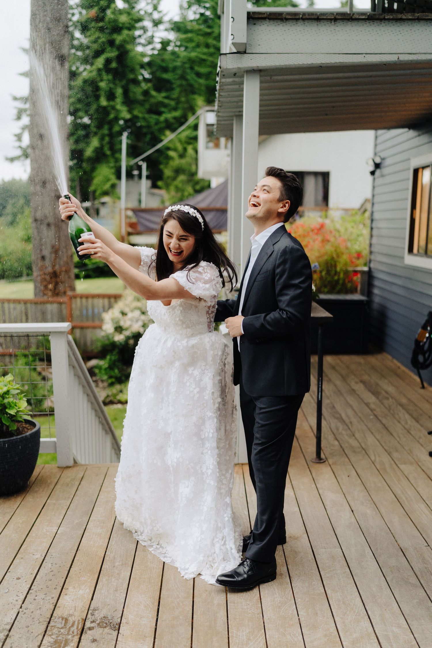 Dancing couple sharing joyful moments on a wooden deck during celebration.