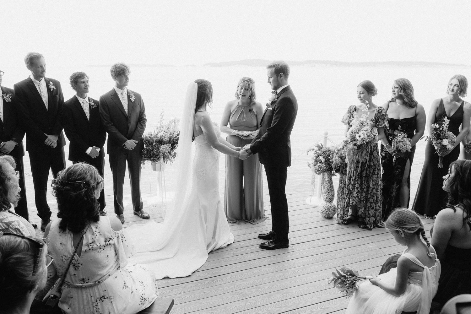 Wedding ceremony taking place in a bright, airy space with guests in attendance.