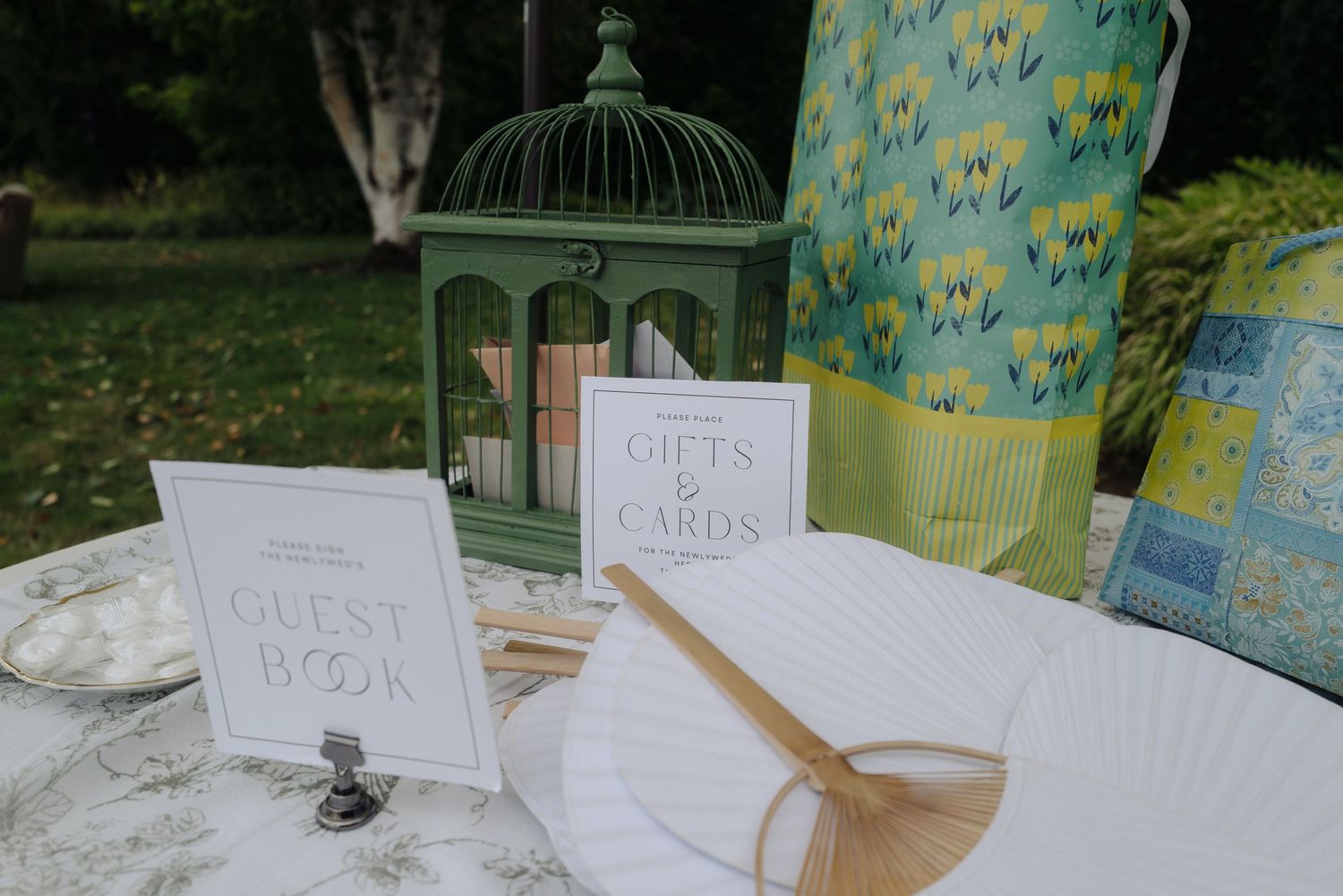Wedding gift table setup with decorative signs and vintage-style decor elements.