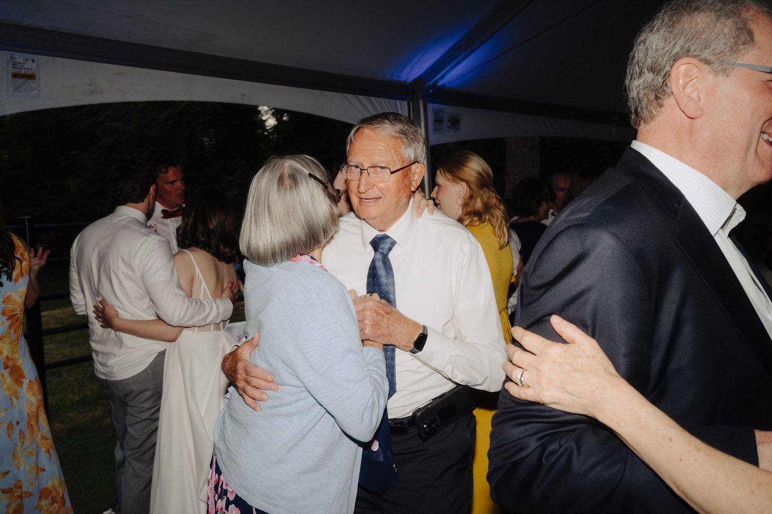 Wedding reception dance floor filled with guests enjoying evening celebrations.