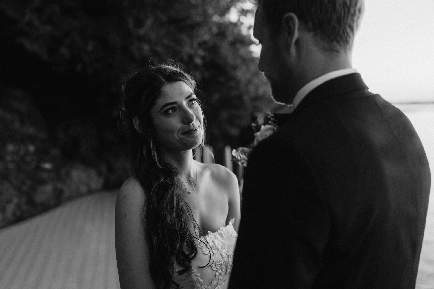 Black and white artistic shot of an intimate wedding ceremony moment.