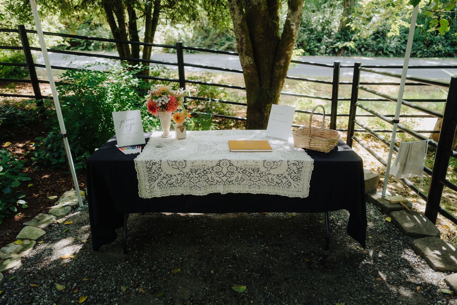 A rustic wedding altar table decorated with flowers and lace in a garden setting.