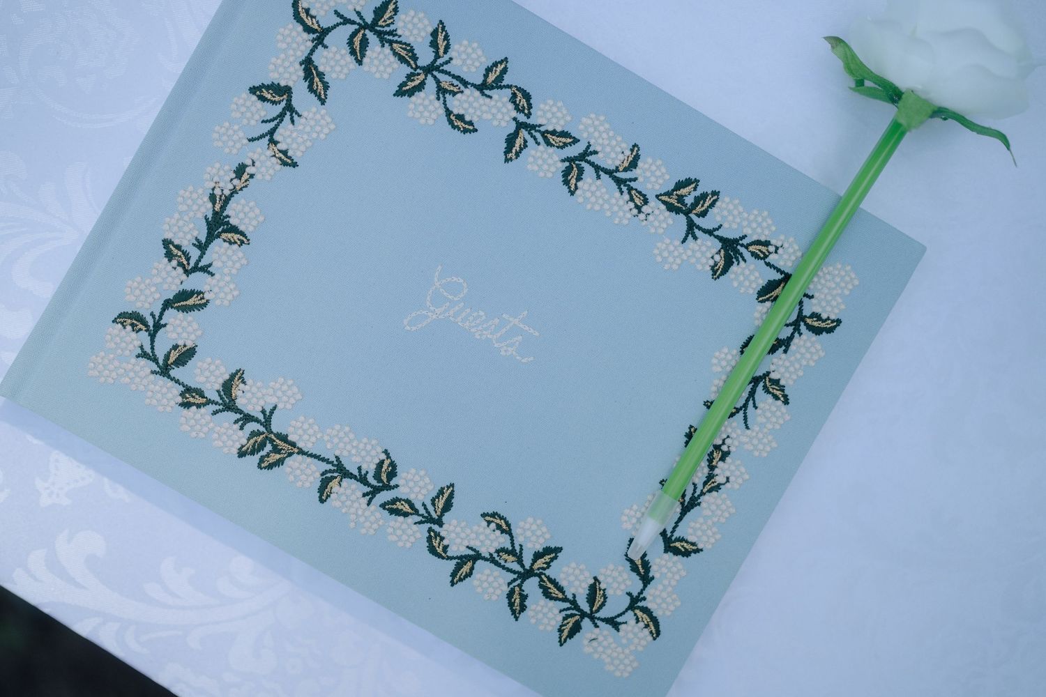Decorative floral vine border designs printed in green ink on light gray paper.
