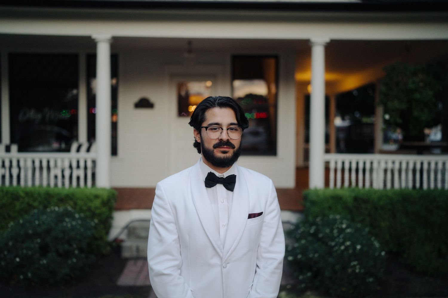 Formal wedding attire and decorations at an elegant outdoor venue.
