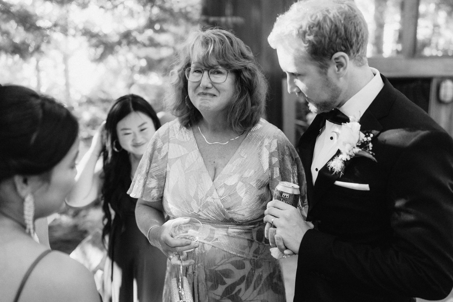 Wedding reception guests mingle and celebrate during outdoor evening event.