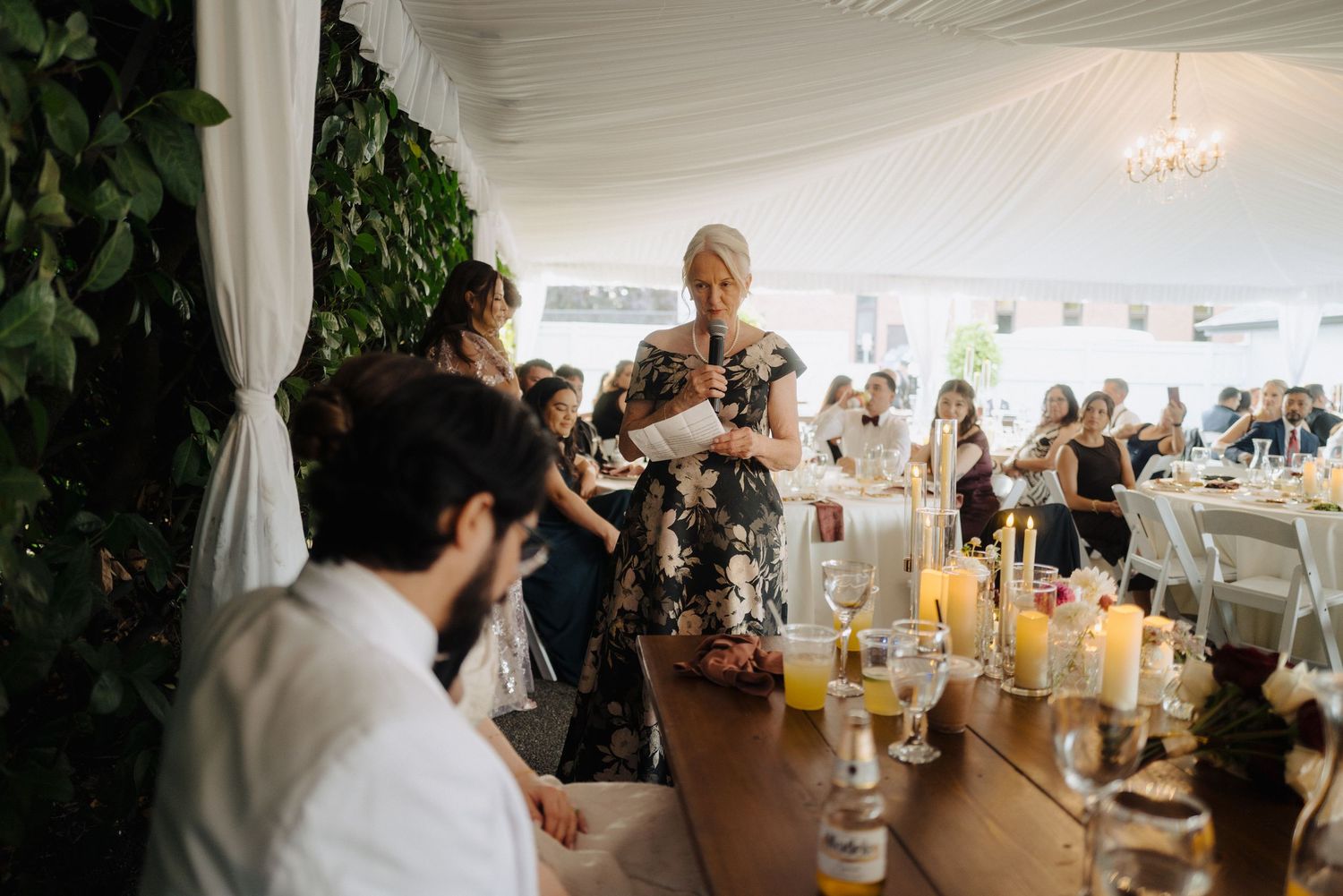 Wedding reception dining area with rustic decor and natural lighting.