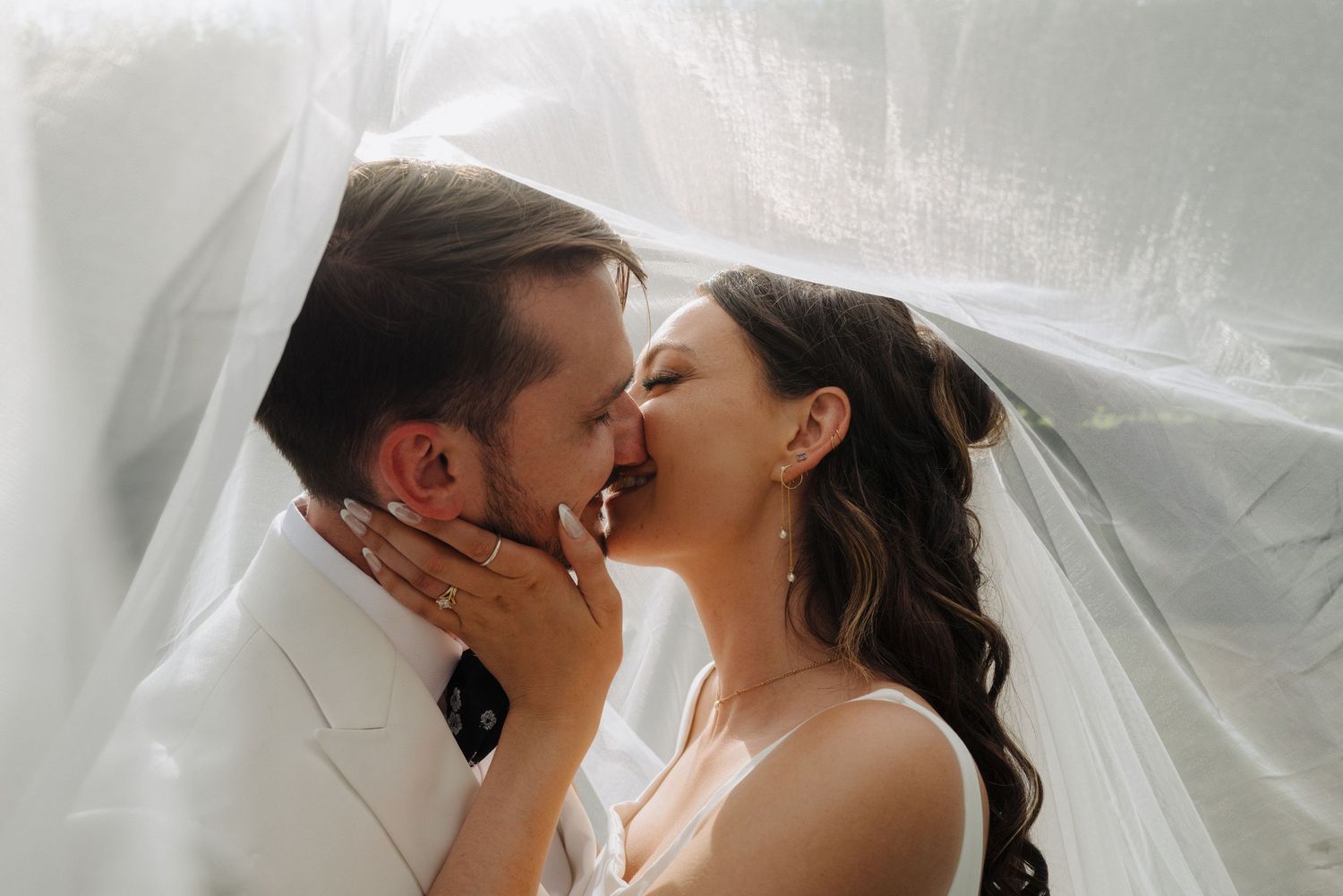 Romantic wedding portraits with soft lighting and delicate veil details.
