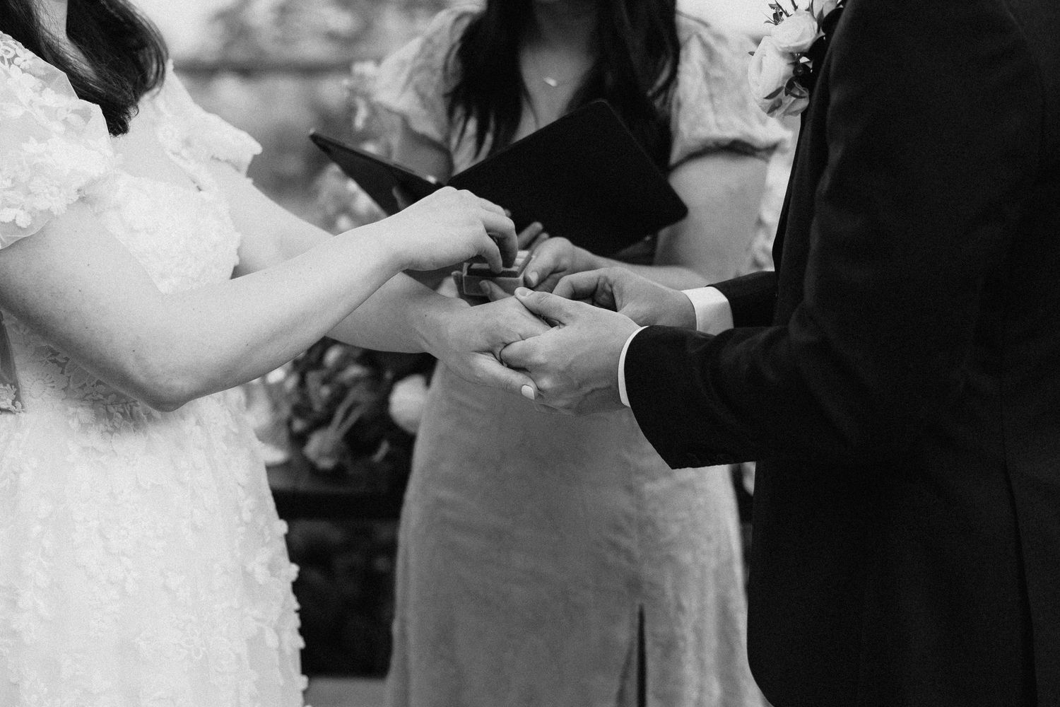 A couple shares a romantic dance moment at their wedding reception in black and white.