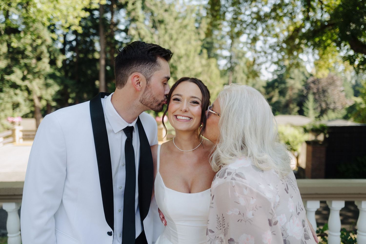 Wedding couple sharing intimate moments during an outdoor photo session in a garden setting.