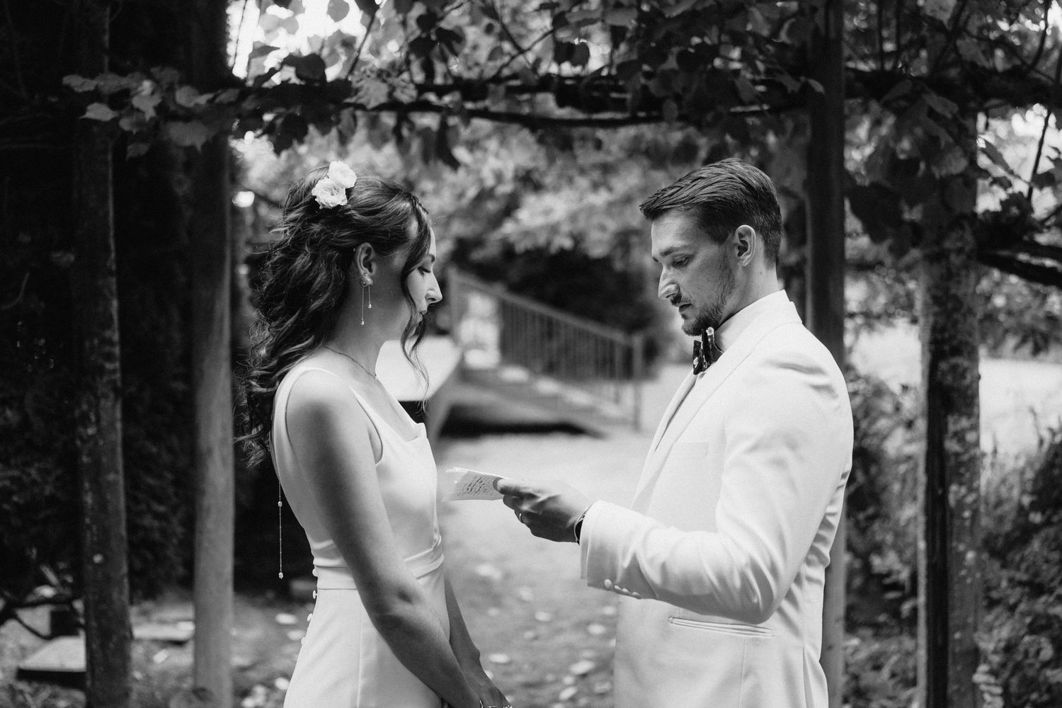 Romantic black and white photo sequence of couple sharing intimate moments in outdoor garden setting.