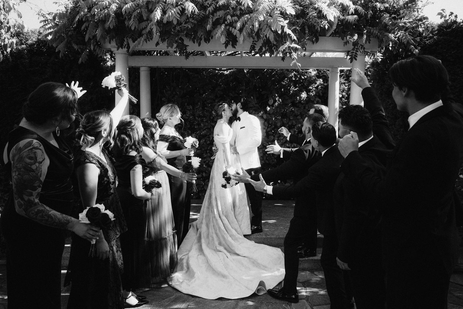 Wedding reception celebration with guests dancing in an elegant outdoor setting.