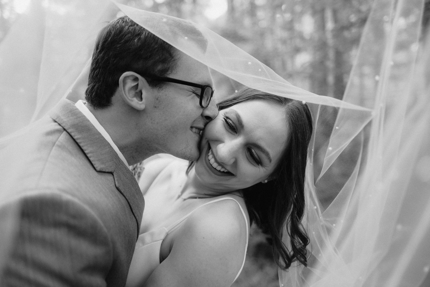 Intimate wedding moments captured through soft focus and romantic lighting in an outdoor setting.