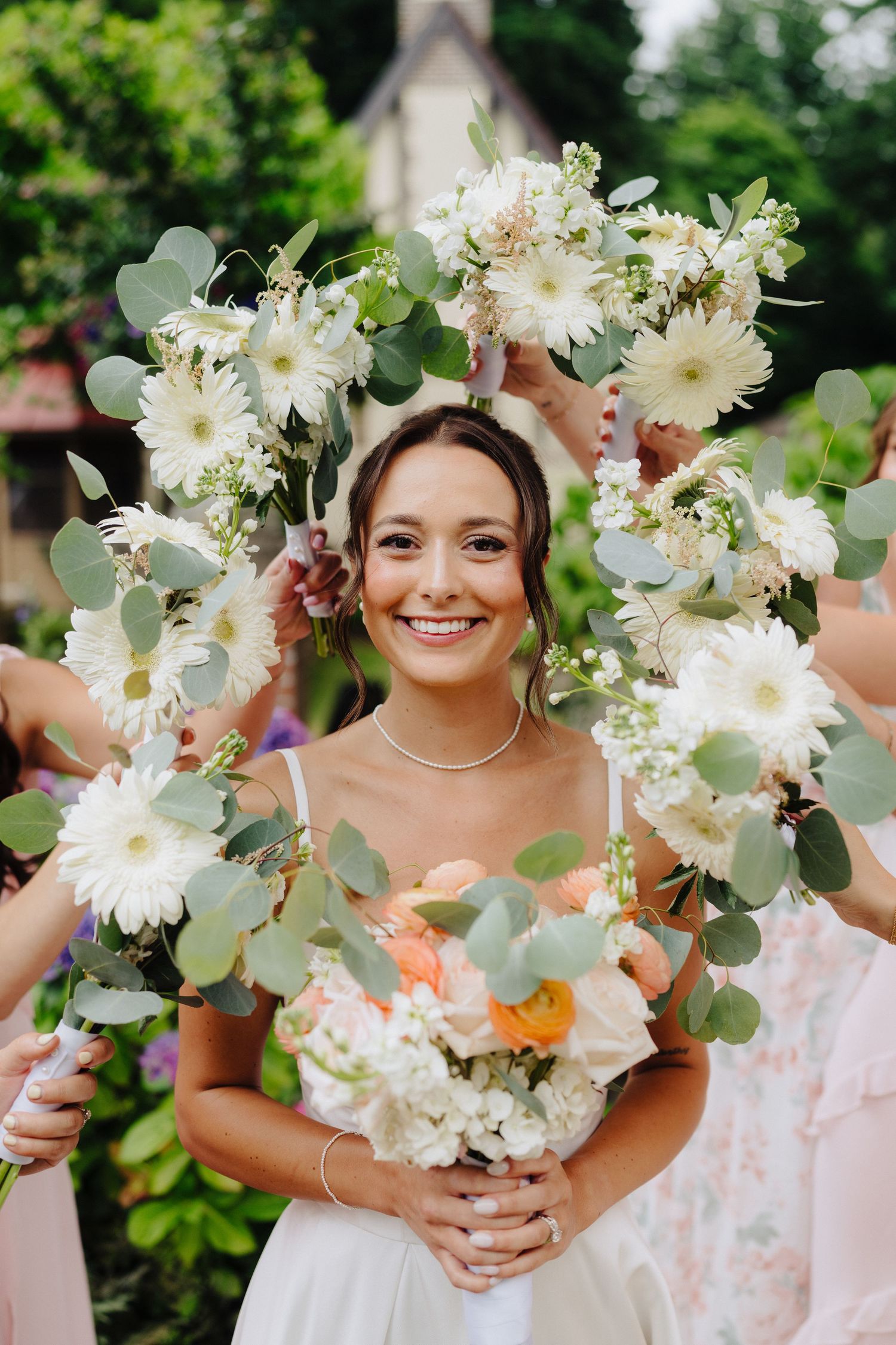 Beautiful white floral bouquets with eucalyptus leaves arranged for a wedding celebration.