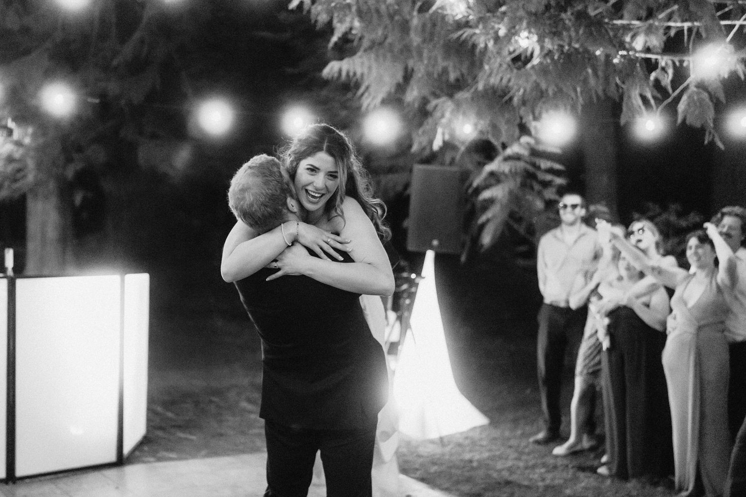 Wedding guests form a sparkler exit tunnel at night for the newlyweds.