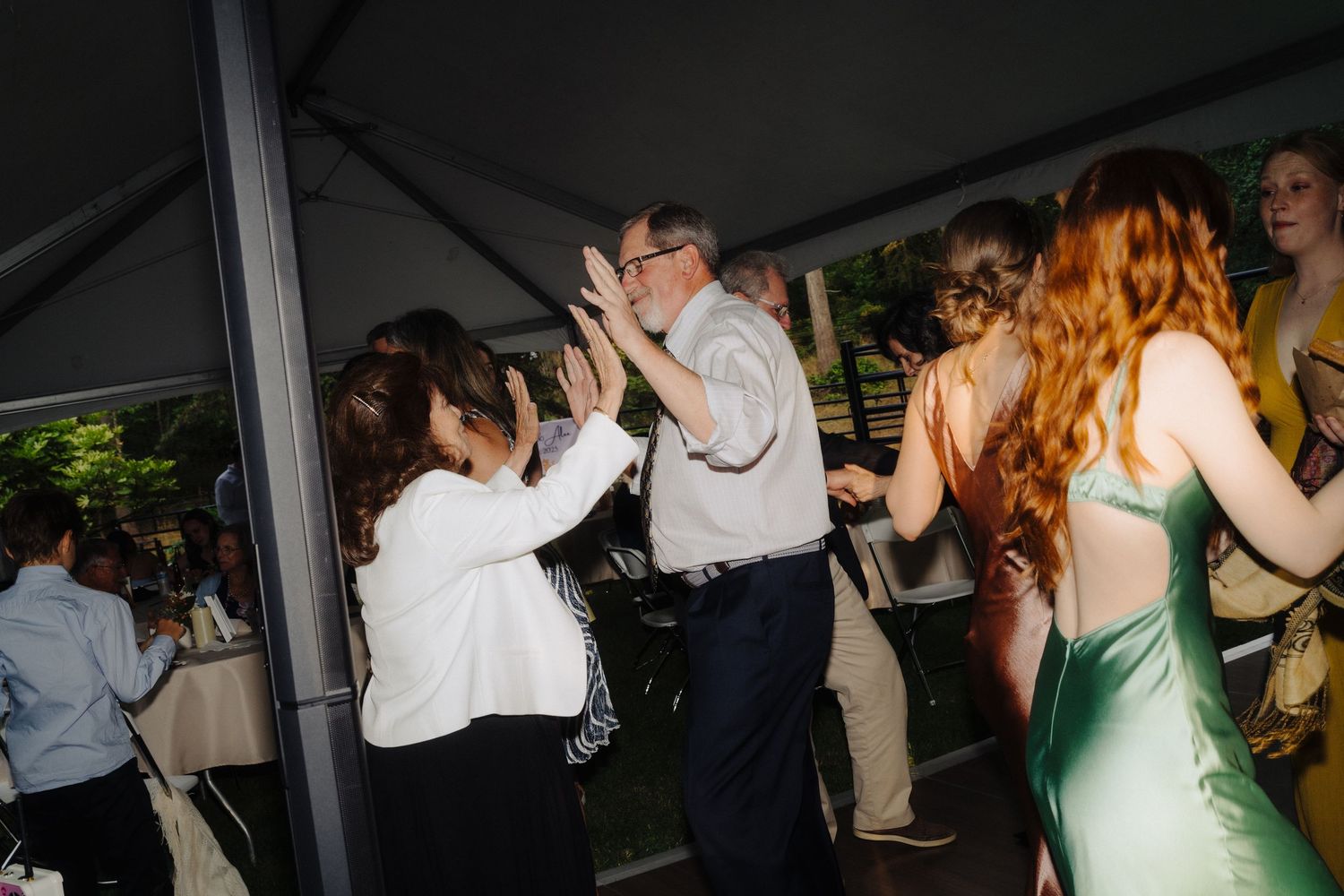 Wedding reception dance floor filled with guests enjoying the celebration.