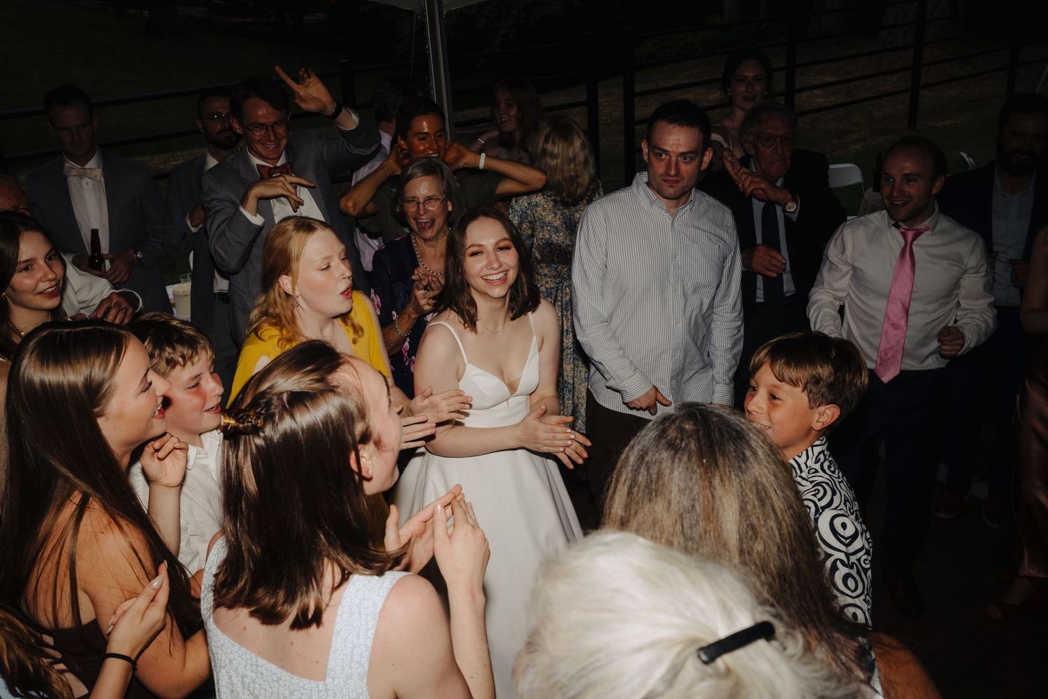 Energetic dance floor scenes from a wedding reception with guests enjoying the celebration.