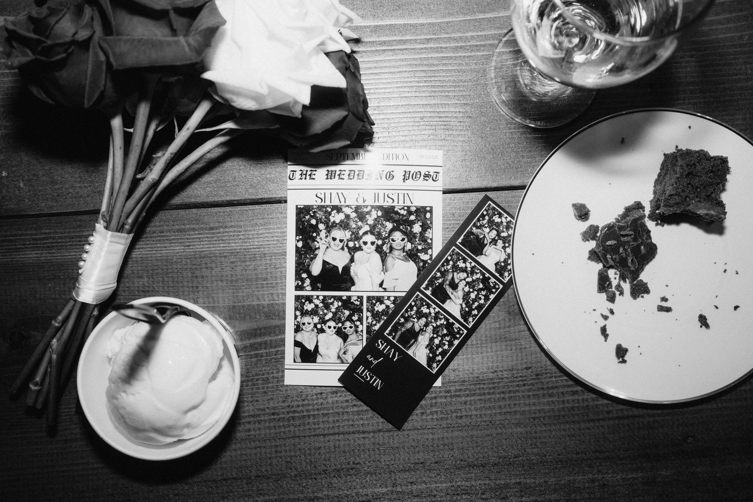 Black and white photo of partially eaten wedding cake slices on plates.