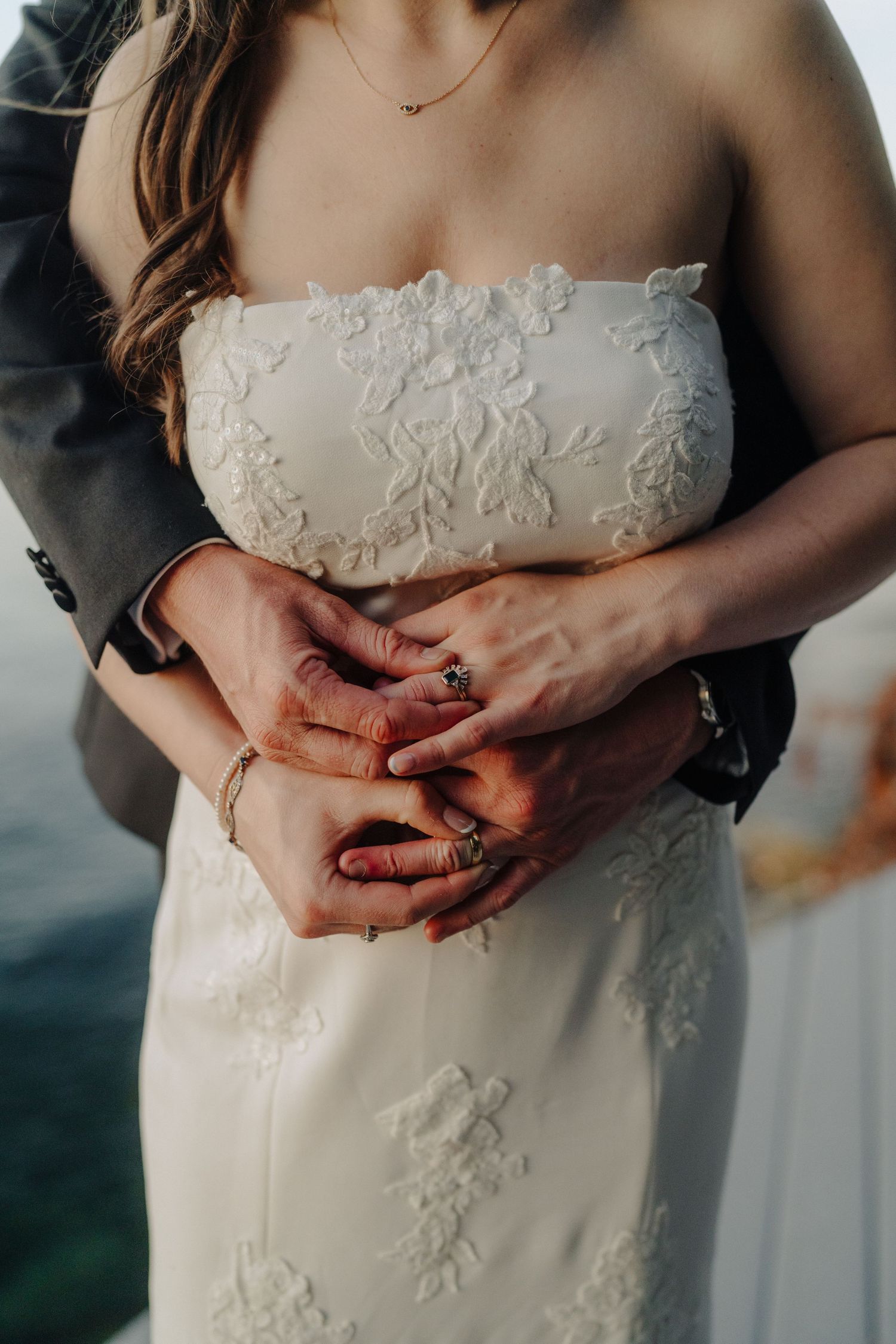 Close-up details of delicate white lace appliques on a wedding dress bodice.