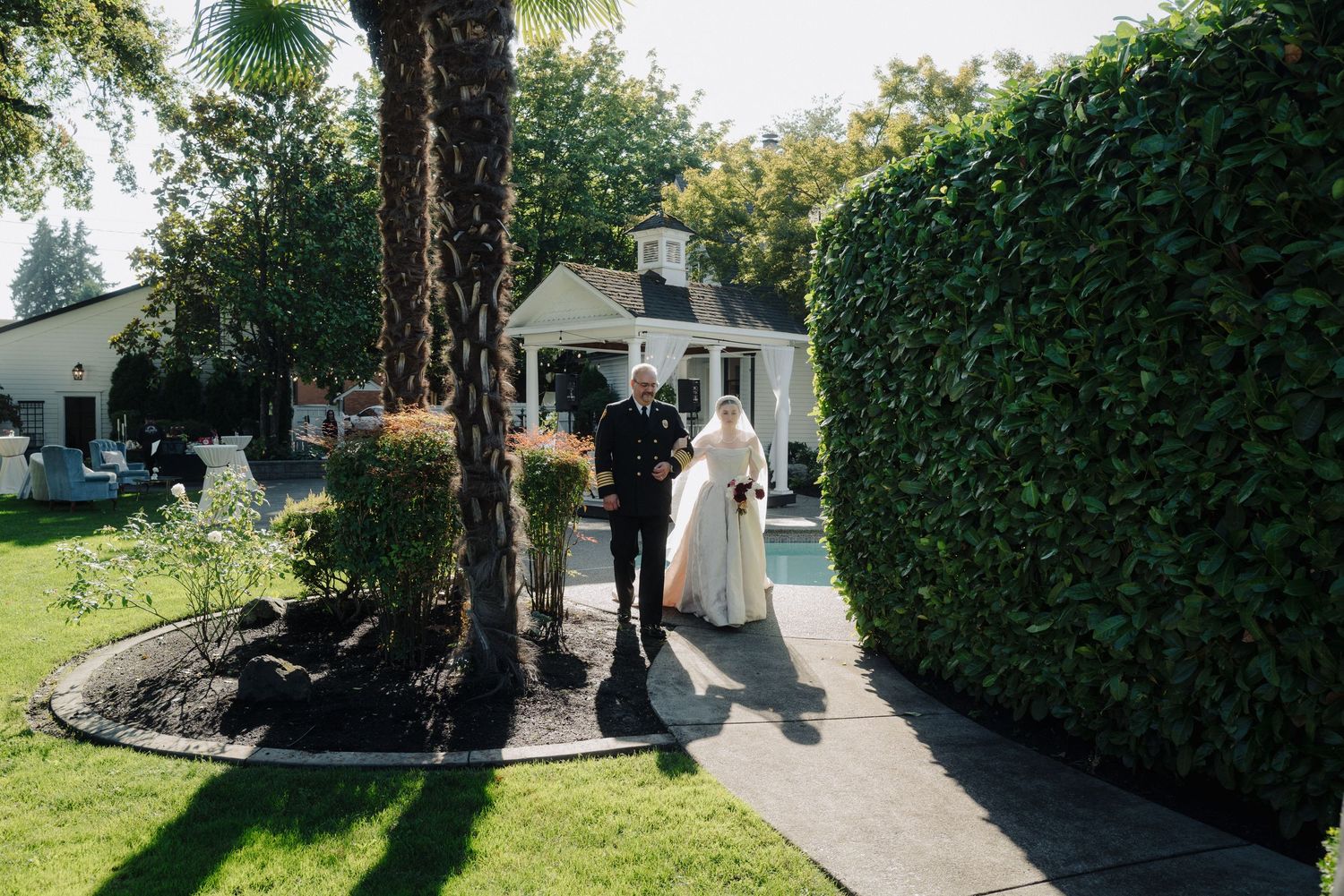 Garden wedding venue with manicured hedges and walking paths.