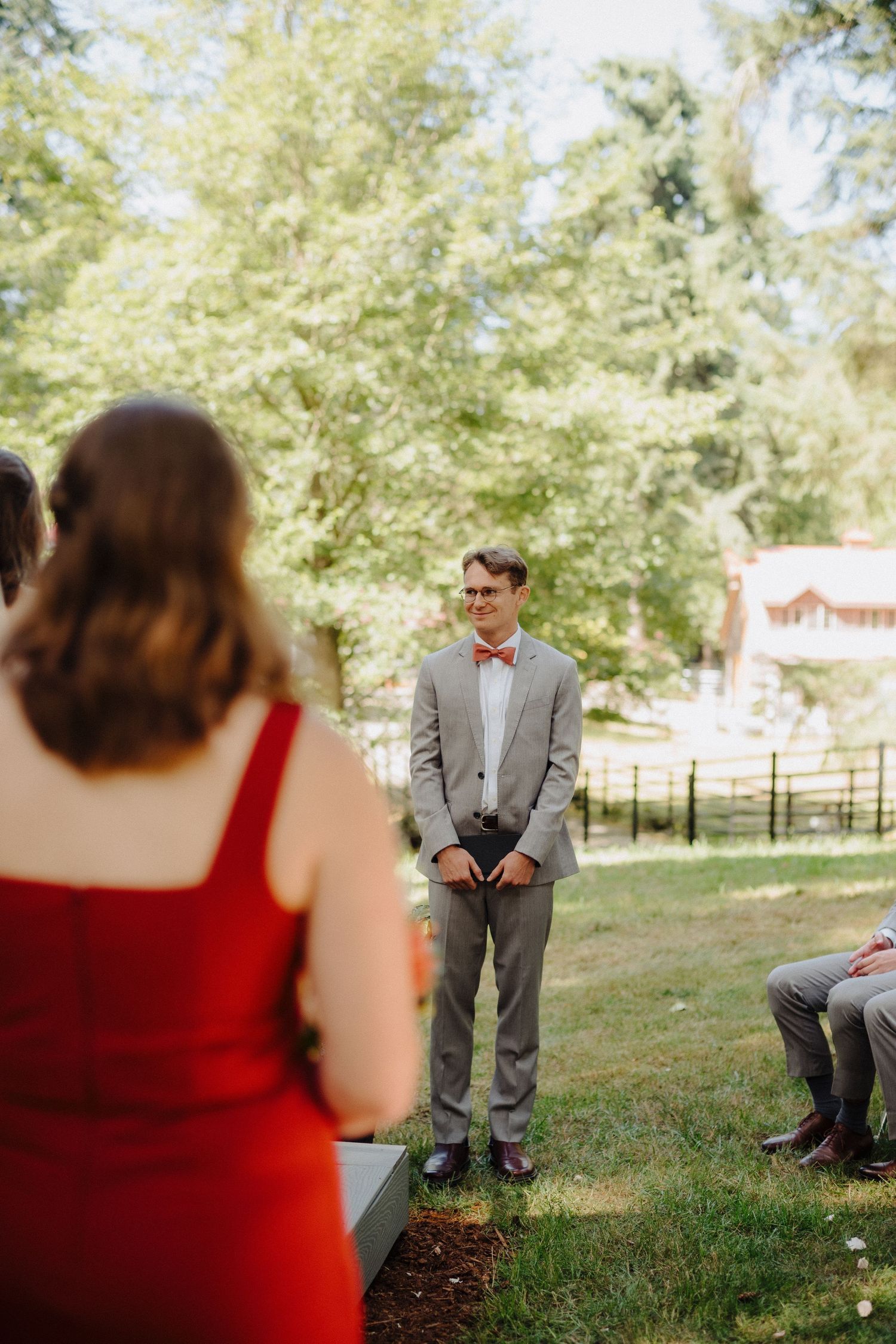 A couple shares a romantic first look moment in a sunlit garden setting.