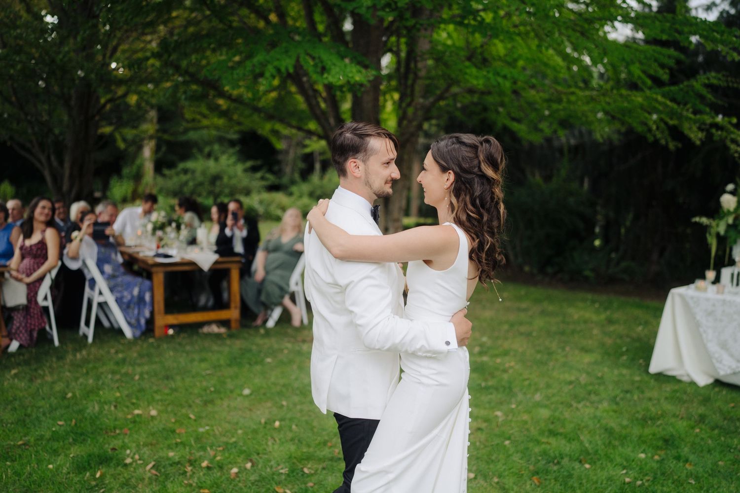 Couple sharing their first dance on outdoor garden wedding reception.