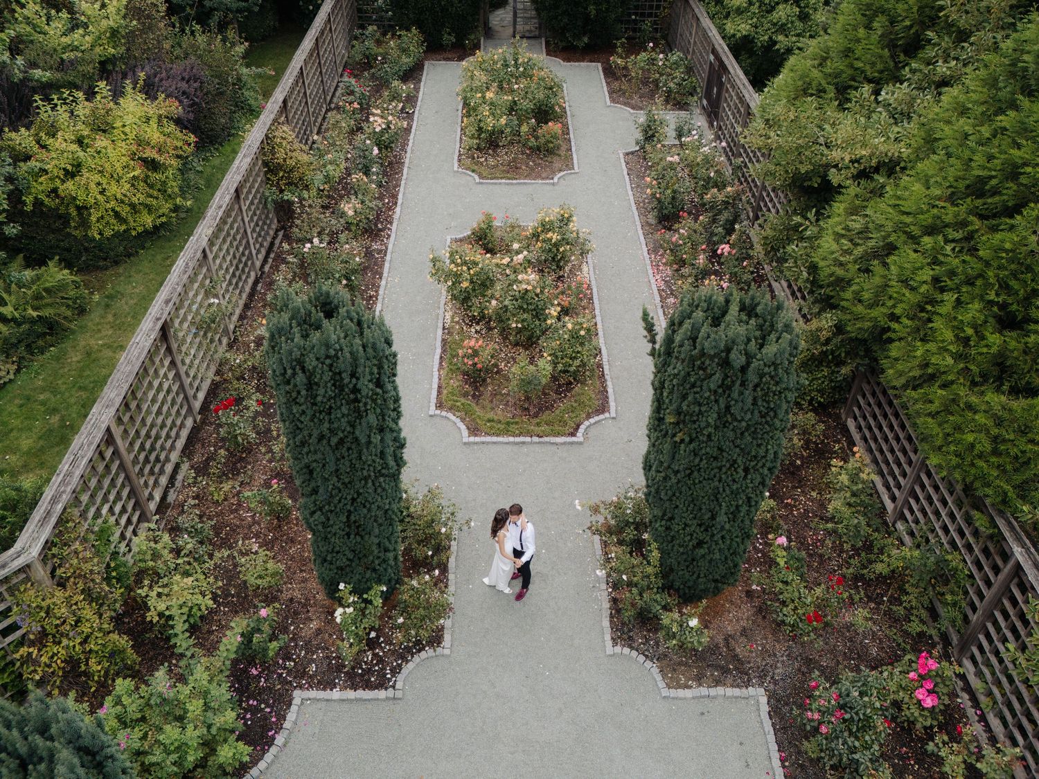 Aerial view of a formal garden path with symmetrical landscaping and manicured hedges.
