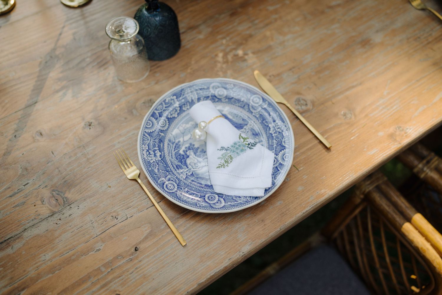 Vintage blue and white patterned plates arranged on a rustic wooden table.