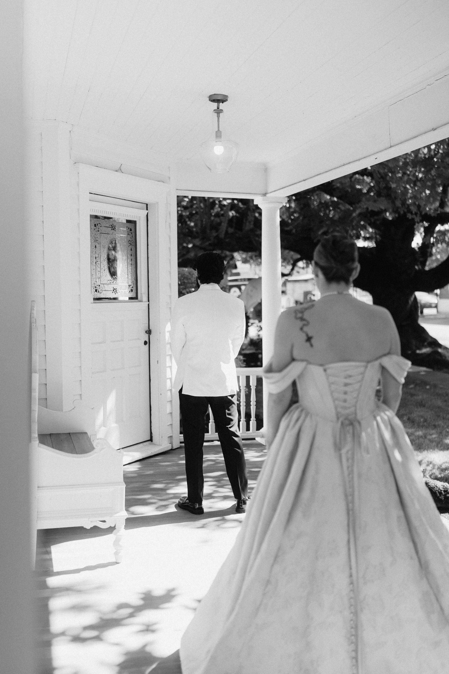 A white wedding dress with a flowing train is shown from behind in a series of elegant shots.