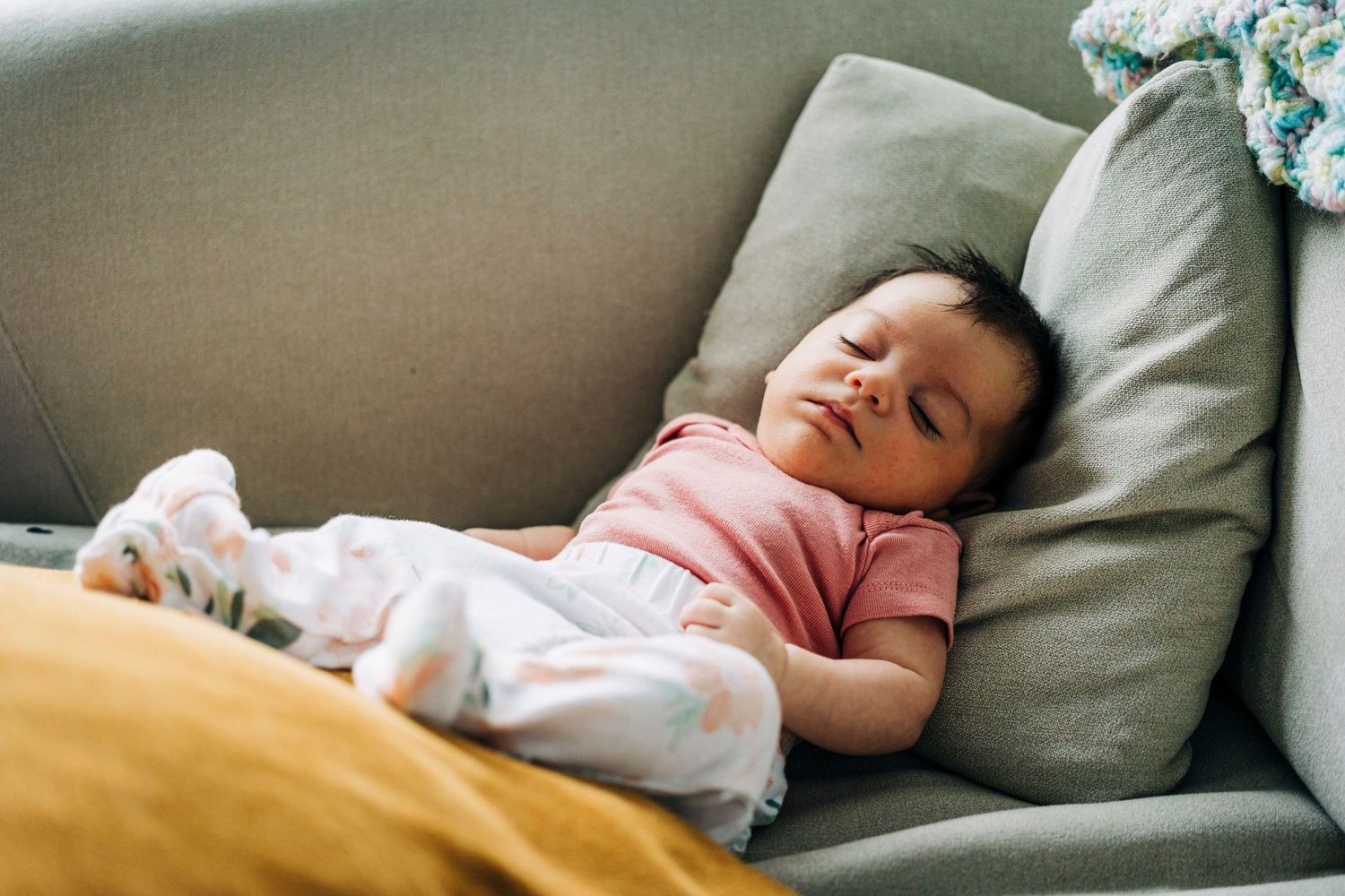 Candid lifestyle photos of peaceful rest and relaxation on a comfortable gray couch.