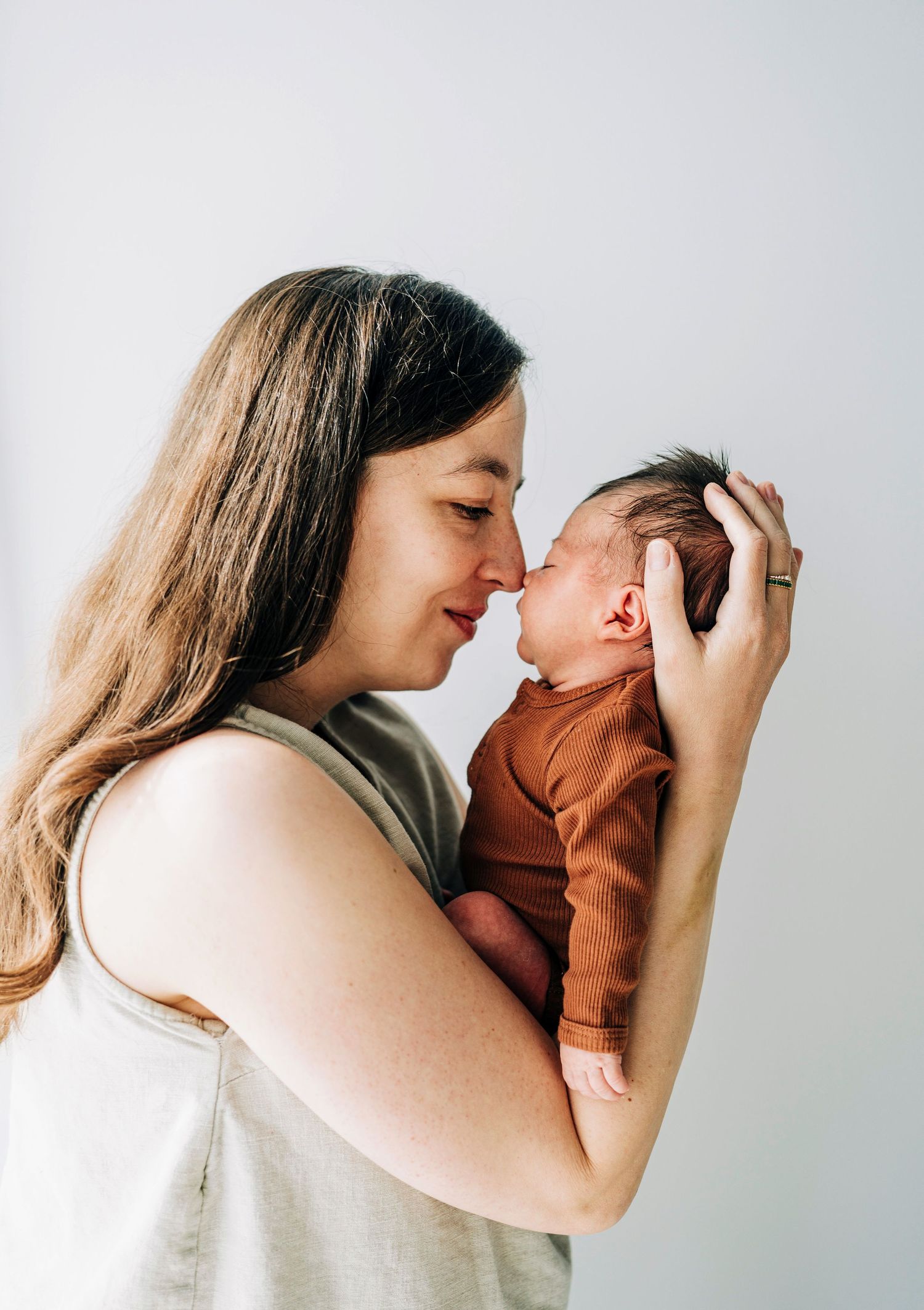 Series of intimate parental bonding moments captured against a white background.