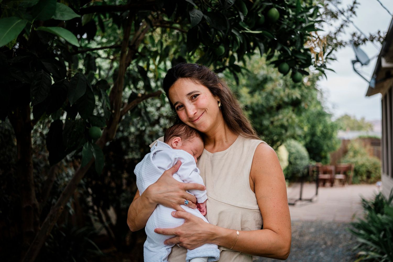 Outdoor lifestyle photography session captured in a garden setting with natural greenery.