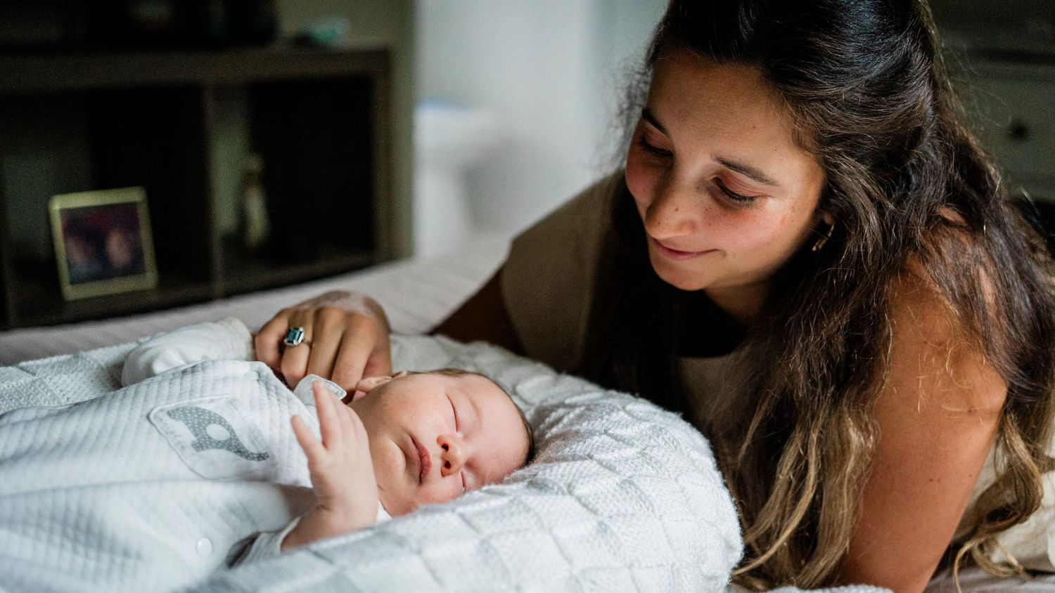 Intimate lifestyle photography with soft lighting and neutral tones.