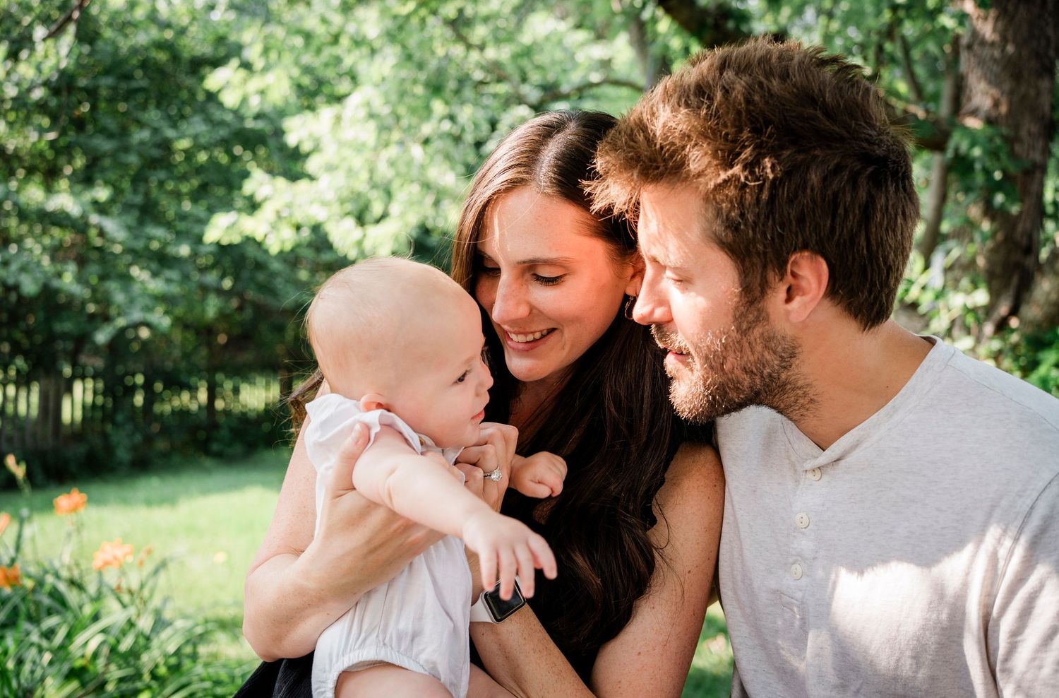 Outdoor family photoshoot sequence showing tender moments in natural lighting.